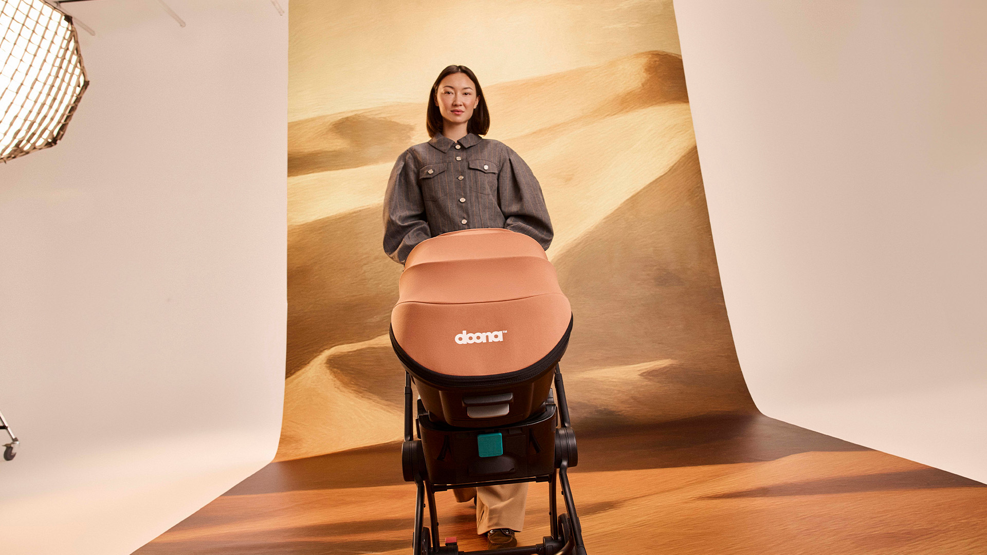 Parent strolling with Doona on city street