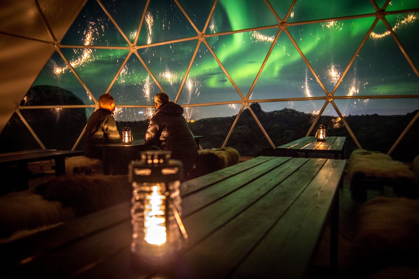 people sitting inside the aurora basecamp geodome