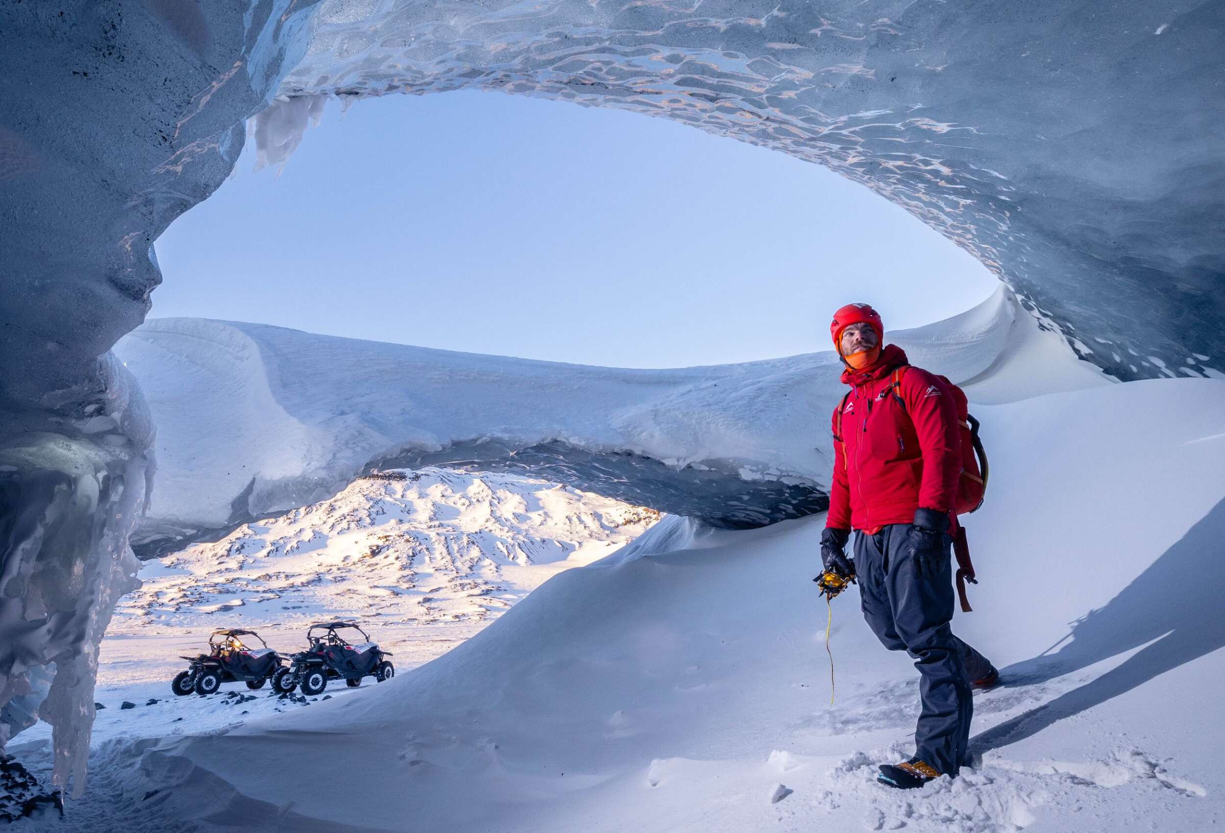 Hiker at the Entrance of Askur Ice Cave, South Coast