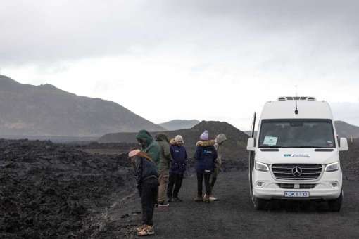 Tour Group Exploring Lava Fields near Grindavík