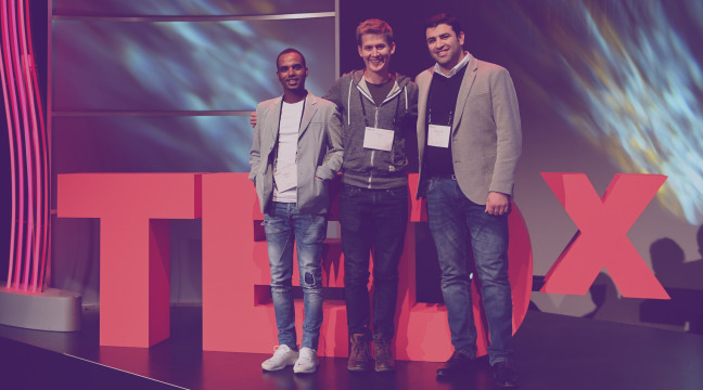 Hussam Allaham, Christian Hirsig und ein Powercoders-Mitglied auf der TEDxZurich-Bühne
