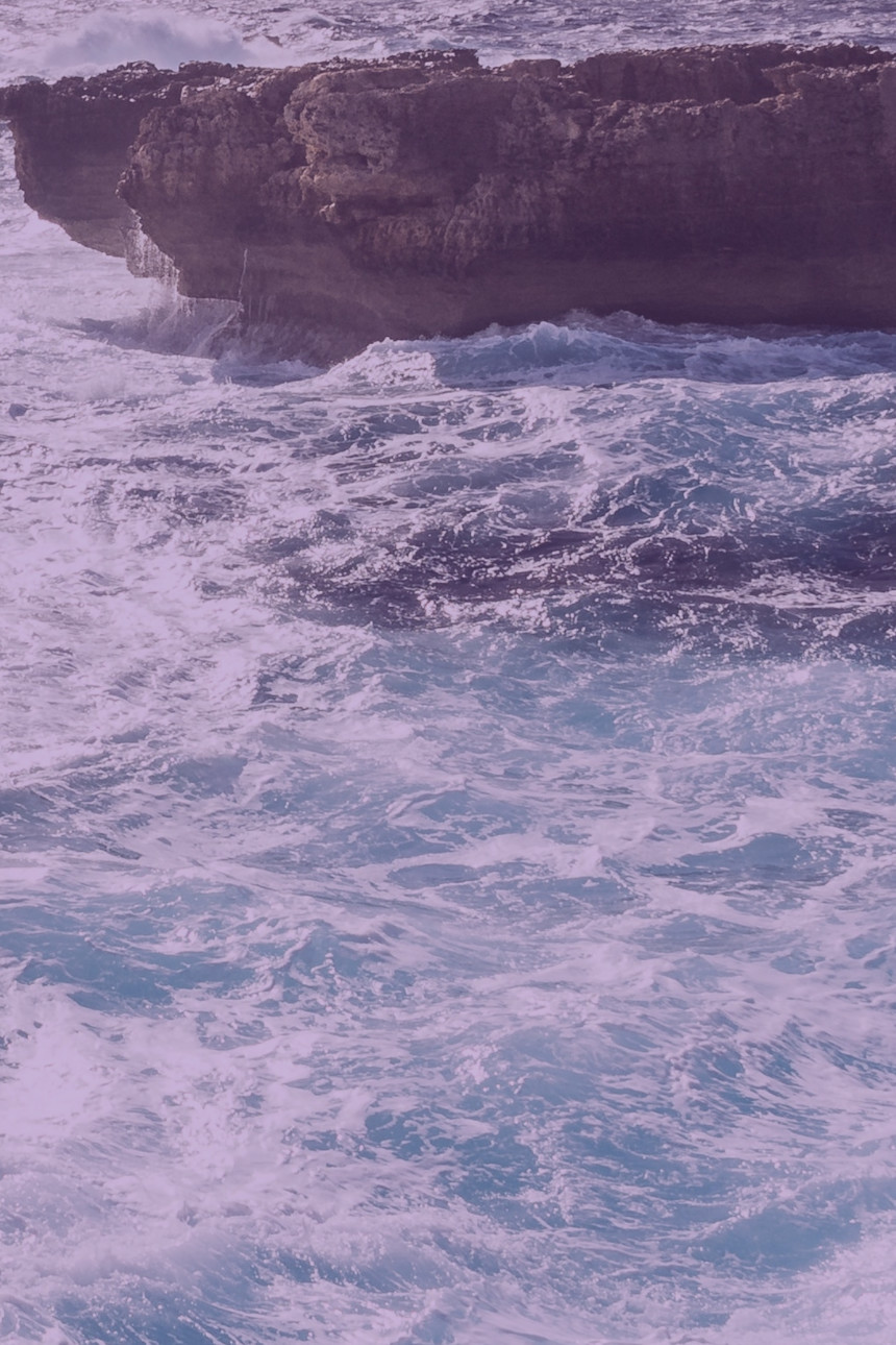 header 3 ein paar wellen die gegen einen felsen krachen