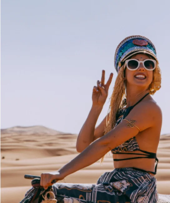 Girl gives a peace sign in the desert