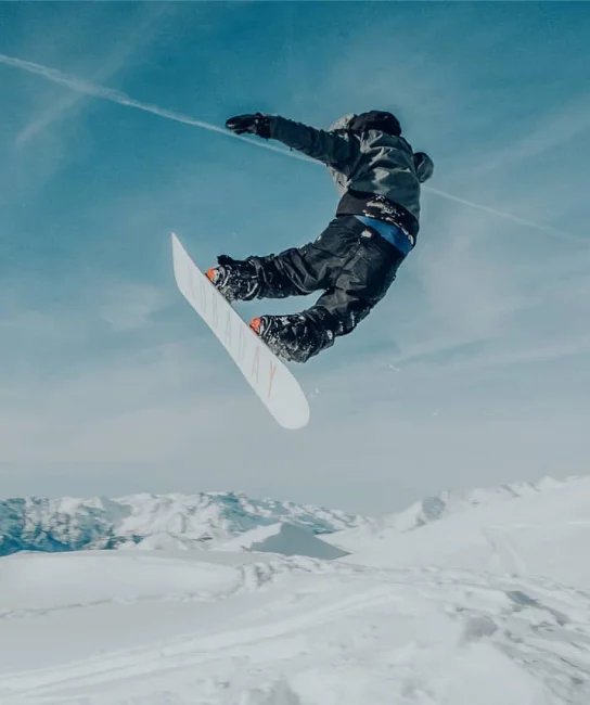 A snowboarder jumps in the air