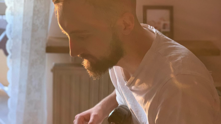 A man sitting and playing guitar