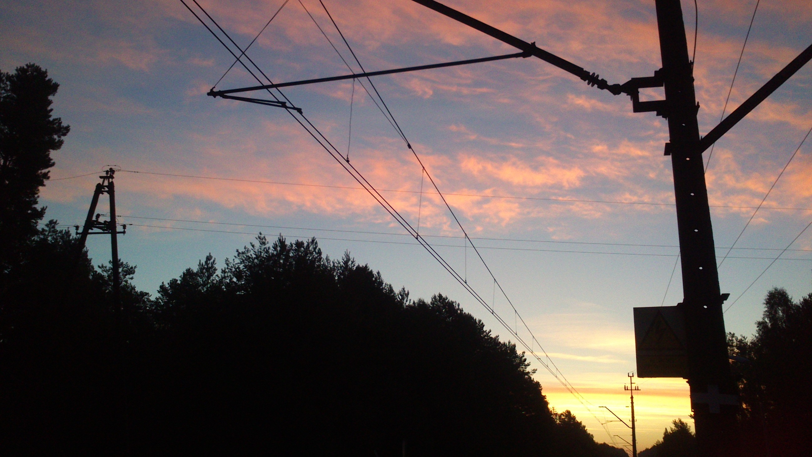 Blue-red sky with electricity lines on the front