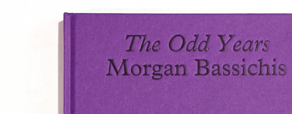 A photo detail of the book Morgan Bassichis's “The Odd Years”. The book is purple with black text.
