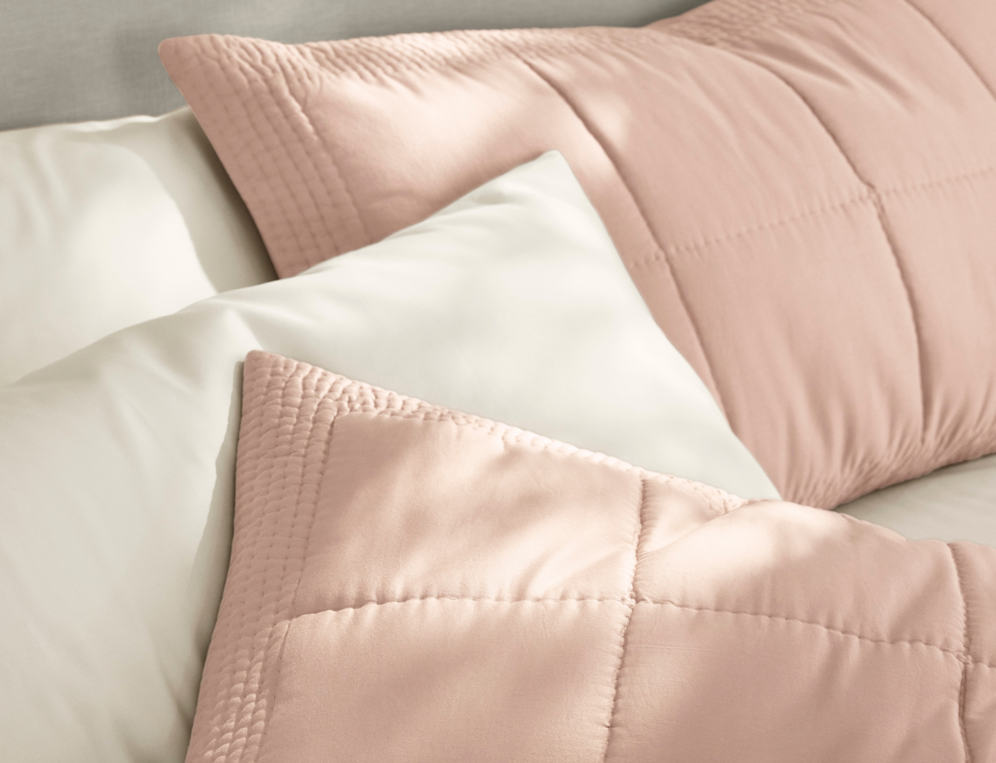 quilted shams in dusty rose on bed