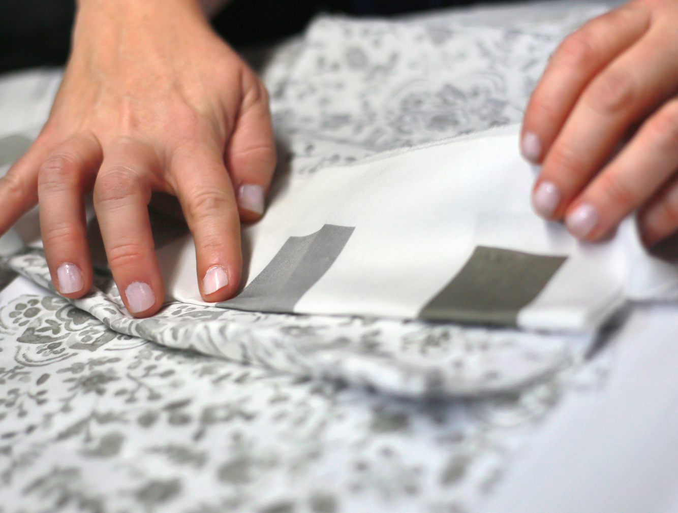 Image of hands on fabric