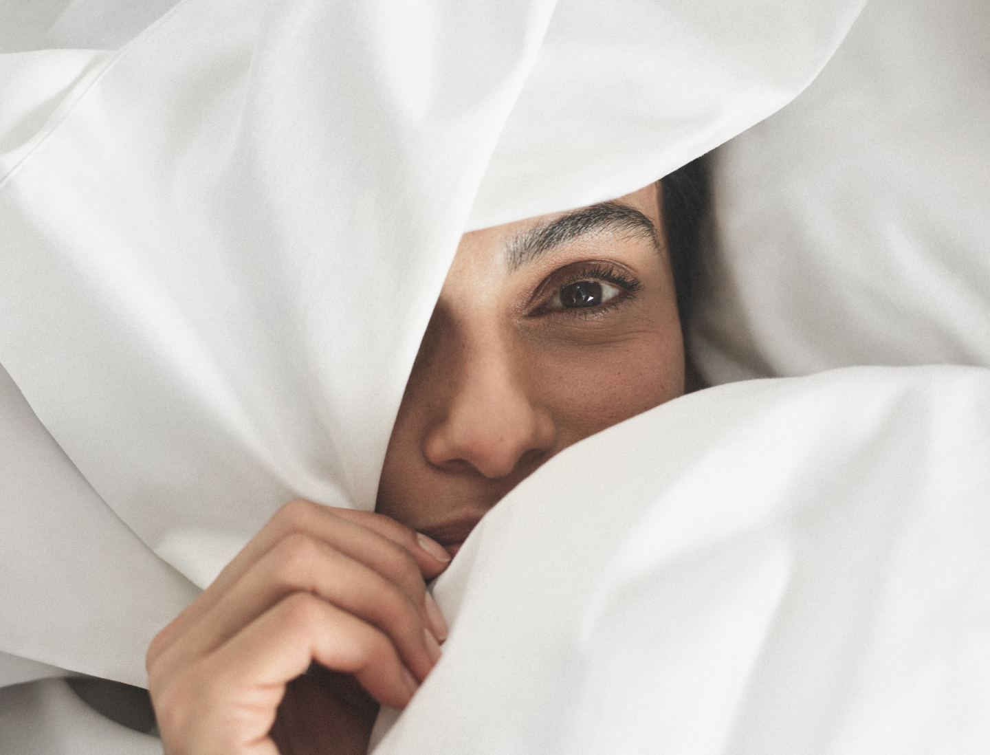 Woman sleeping in Percale Hemmed Sheet Sets in White