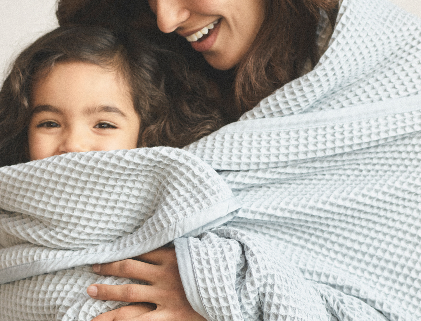 Mother and daughter wrapped in Waffle Bed Blanket