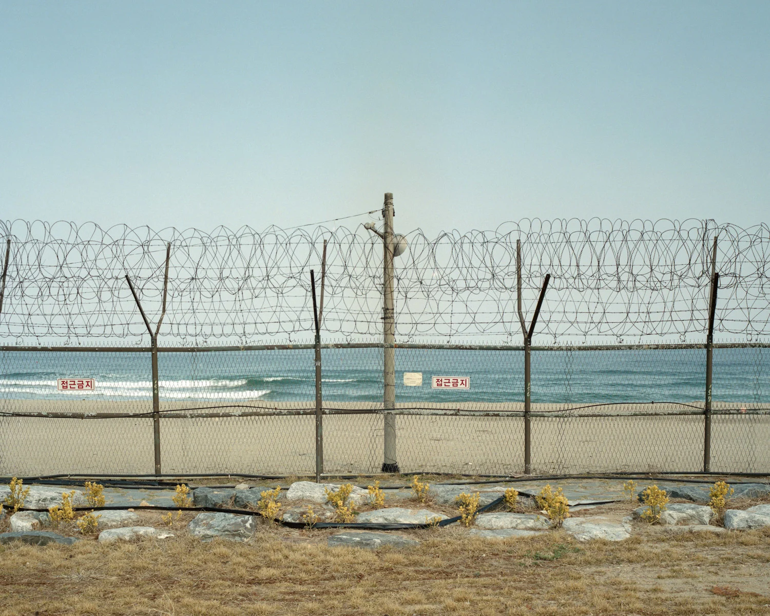 Barbed wire across a South Korean beach near the North Korean border