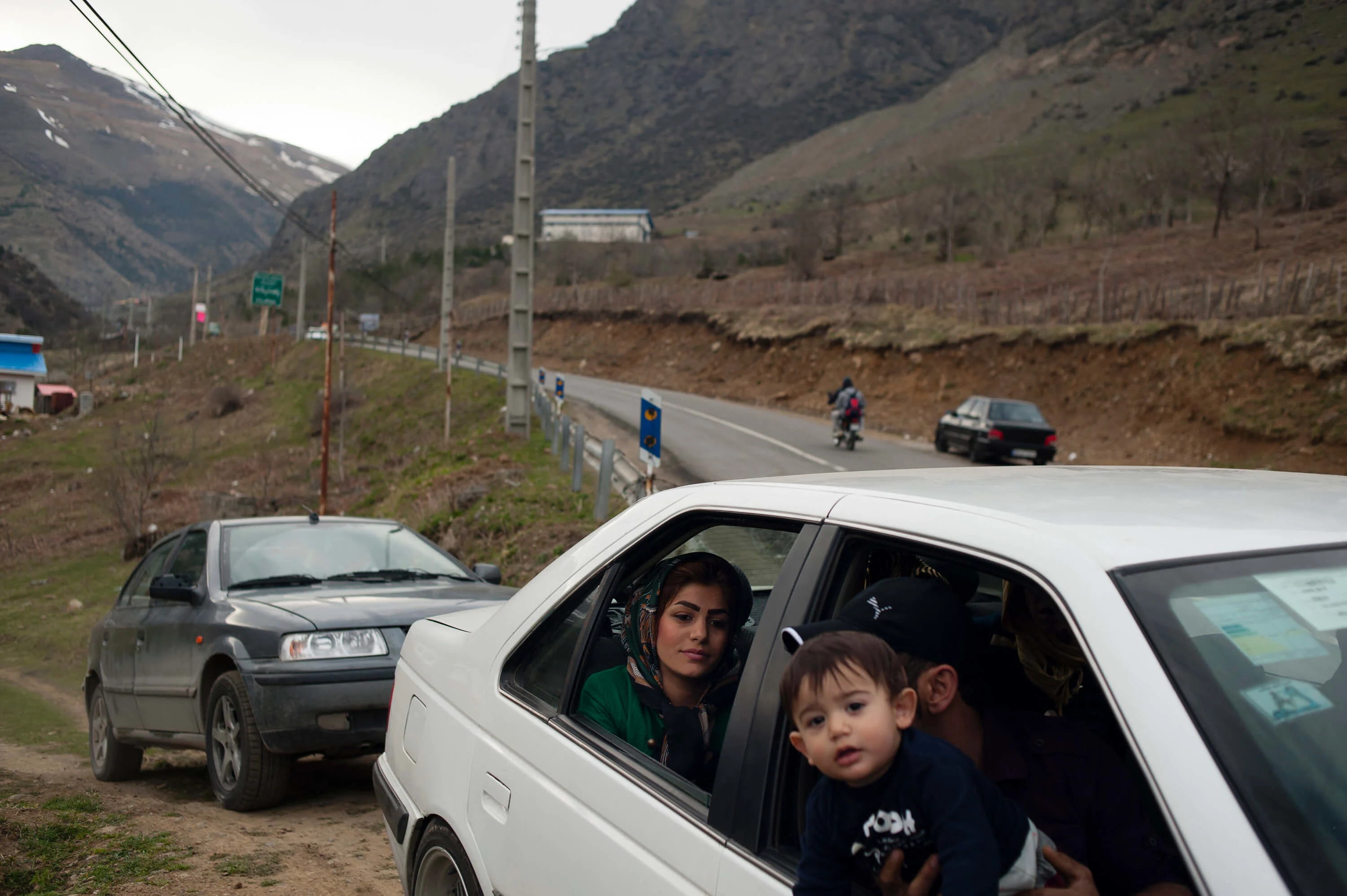 A family drive out of a open pit where tourists and families have made a stop to enjoy the scenery, during No Rooz holiday, which marks the beginning of Iranian New Year.