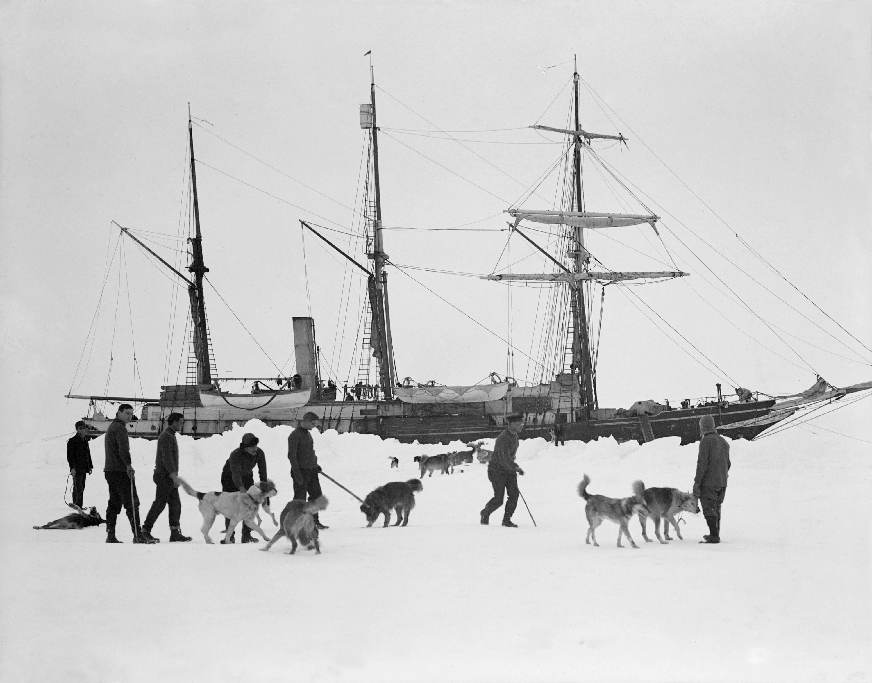 Dogs and men on ice, with Endurance behind. Photo by Frank Hurley © Royal Geographical Society (with IBG)