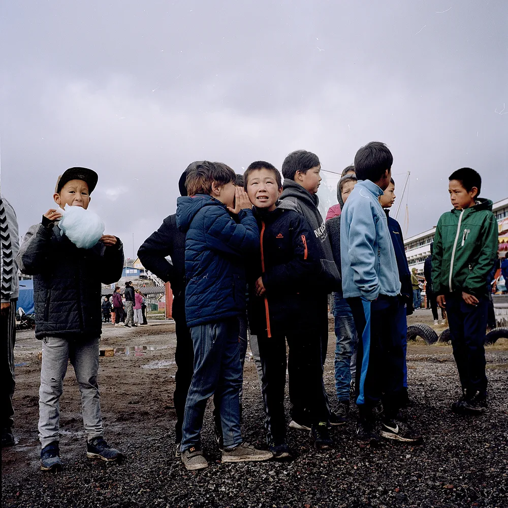 A group of friends attending a concert at Tivoli Nuuk, a free funfair which invites local bands to perform on stage.  |  Inside the Manhattan, one of Nuuk’s nightclubs.