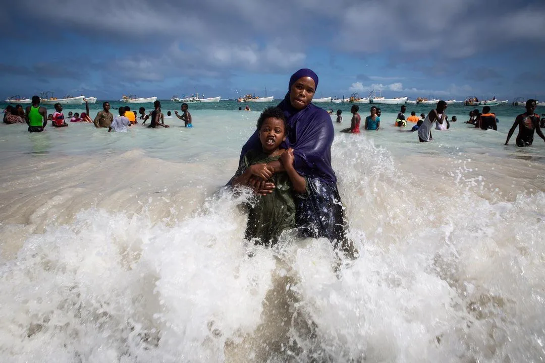 A mother and her daughter play in the ocean at Liido beach, Mogadishu