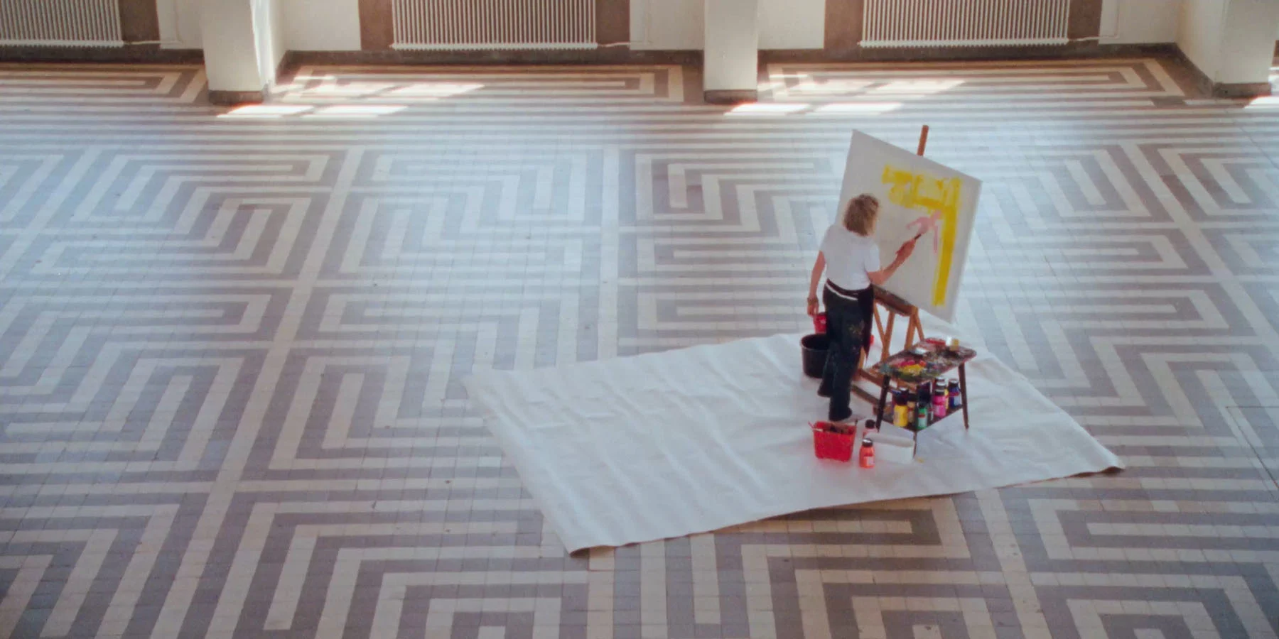 A short clip from the film “Hetty” showing artist Hetty van der Linden painting onto a blank canvas in the middle of an early 20th century brutalist building.  
