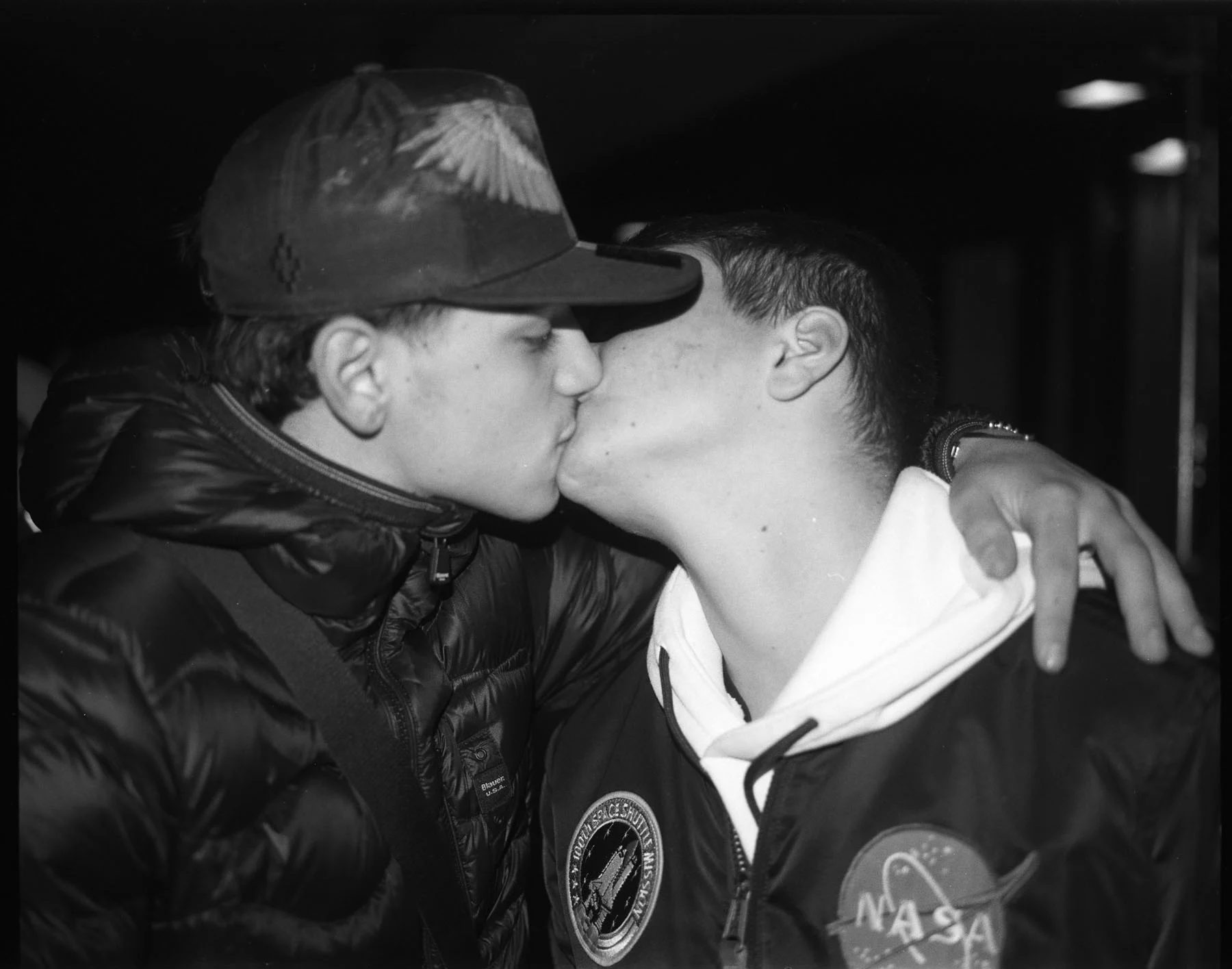 A black-and-white photo of two teenage Neapolitan boys embracing