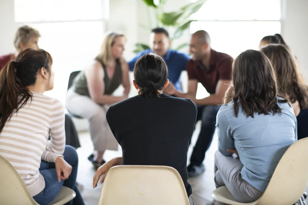 Group Therapy: Several individuals sitting in a circle during group therapy Group Therapy: Several individuals sitting in a circle during group therapy