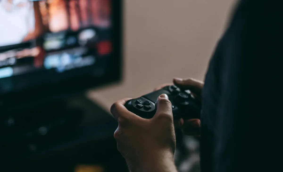Video Game Addiction: Man intensely holding a video game controller
