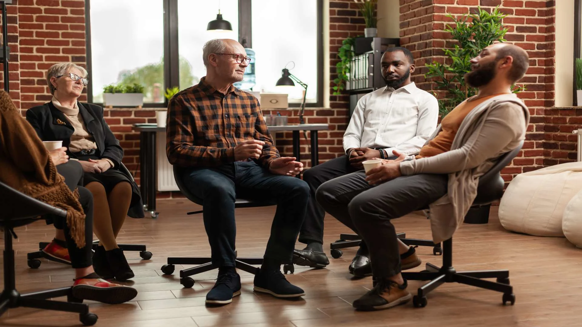 Opioid overdose recovery support group discussing addiction and relapse prevention in a rehabilitation setting.