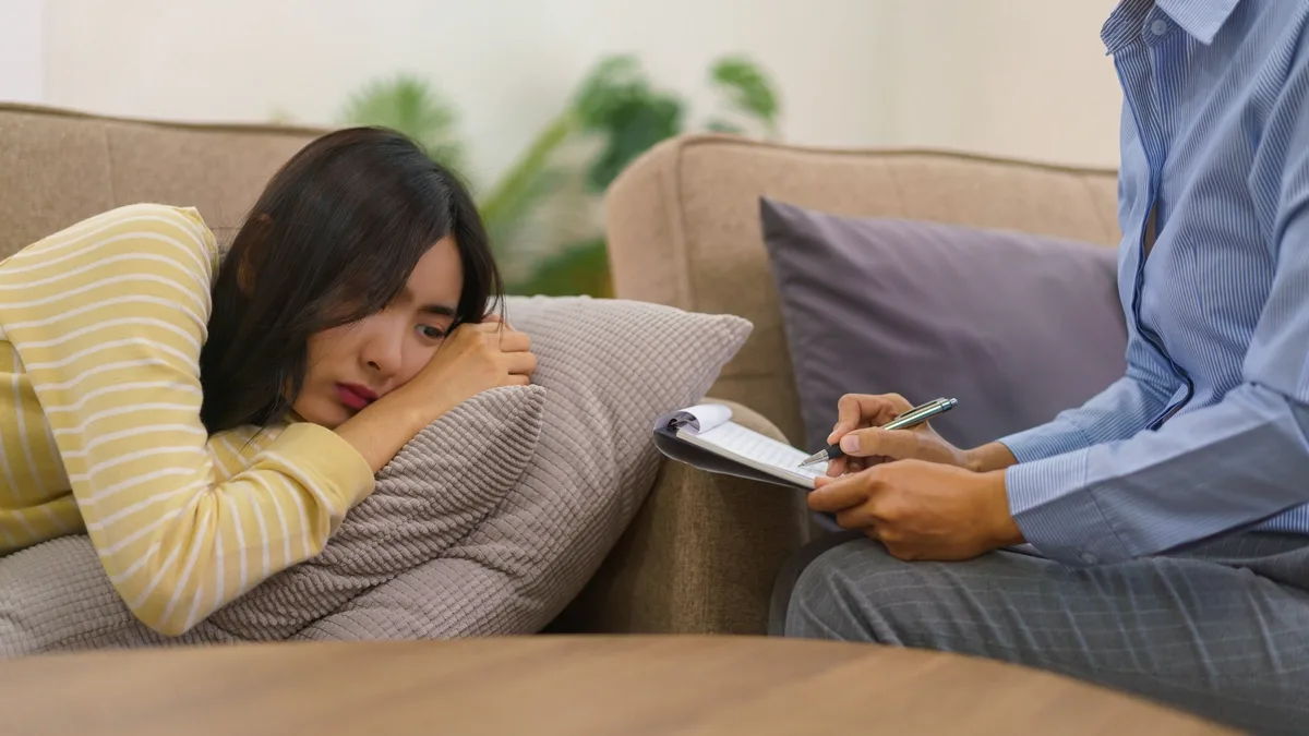 Sad Patient with Simple Schizophrenia Laying on Couch