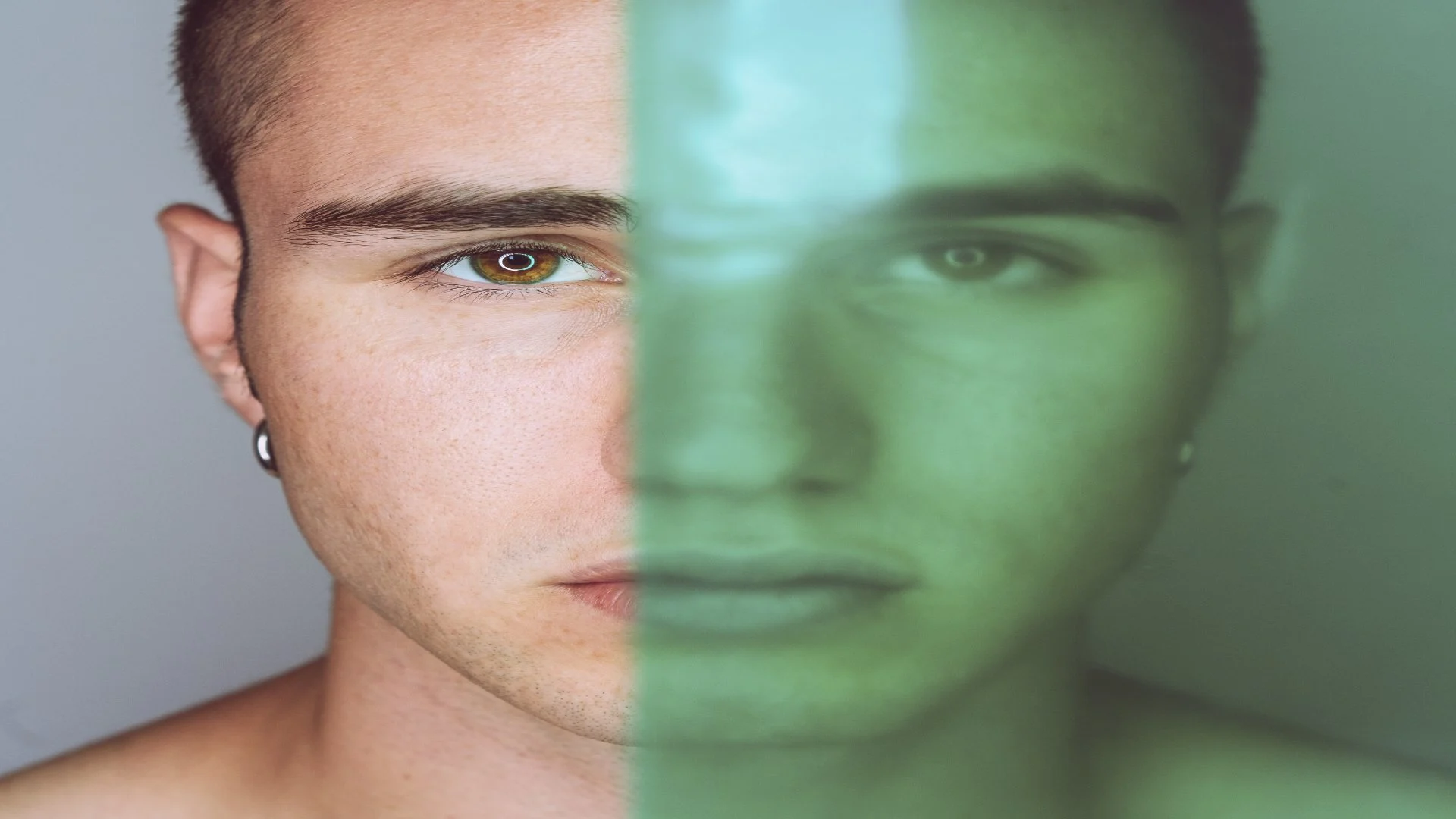 Portrait of a young man with half his face clearly visible and the other distorted, visually representing the duality of mood states and how a person with bipolar thinks and feels.