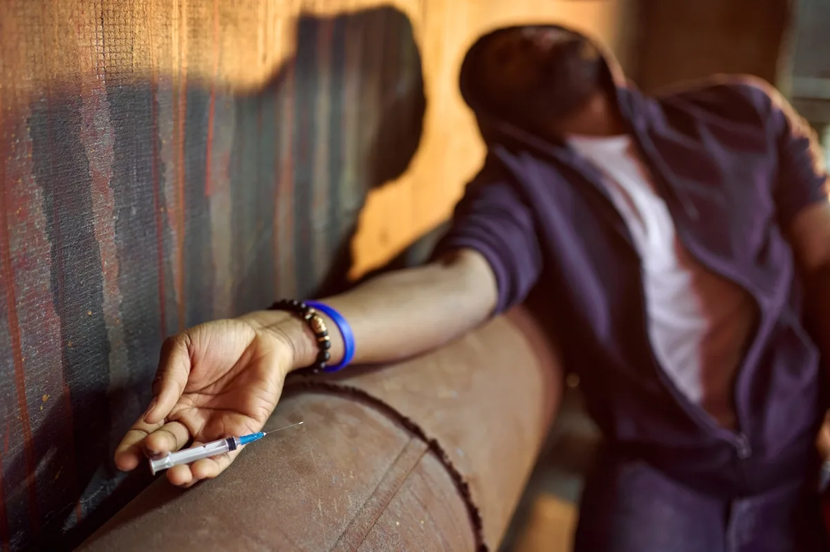 Meth Addiction: Man passed out holding a syringe