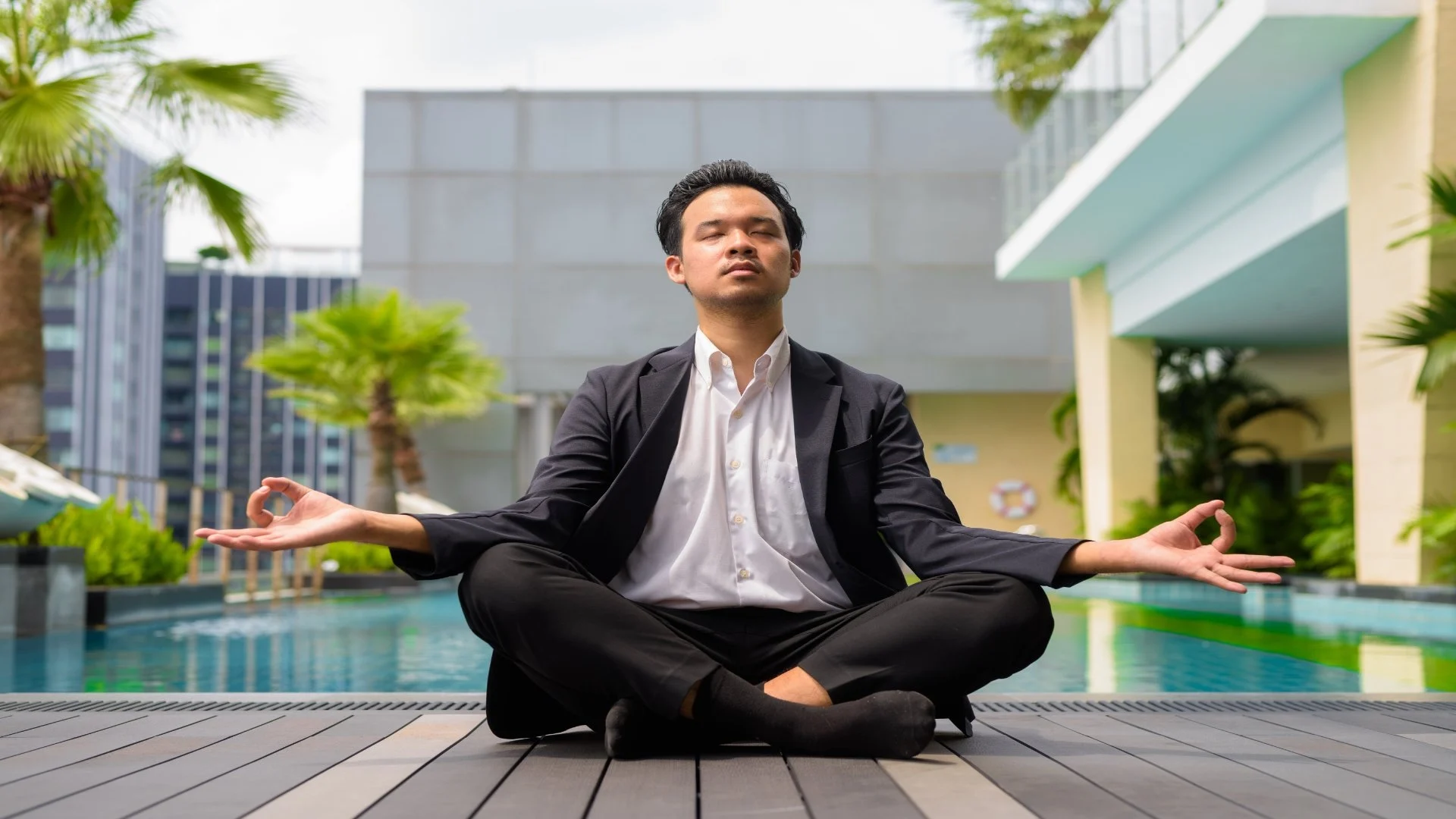 asian-businessman-wearing-suit-and-doing-yoga-and-2025-01-29-03-27-18-utc