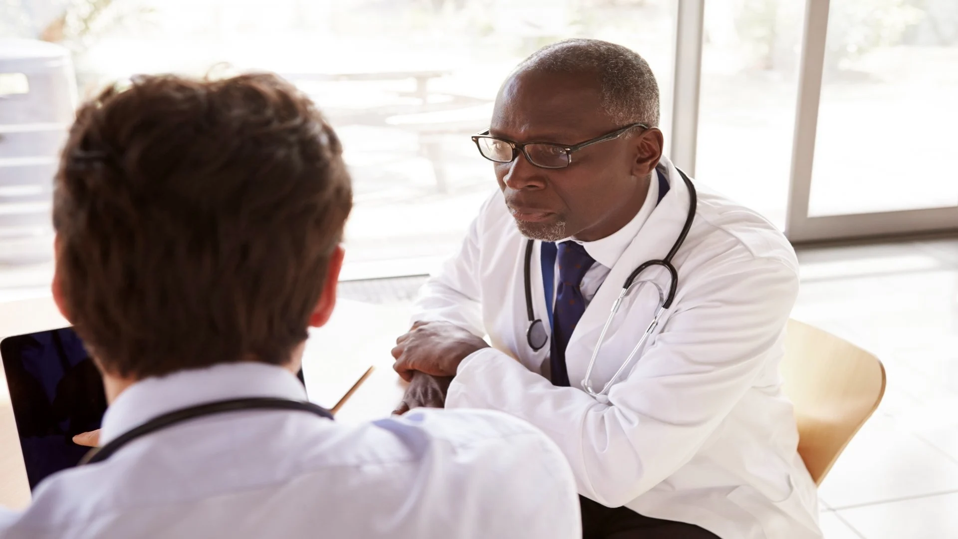 two-senior-healthcare-workers-in-consultation-ove-2024-10-21-22-09-12-utc