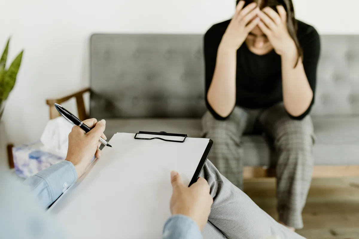 Crisis Stabilization - Woman on Couch Stuggling Crisis Stabilization - Woman on Couch Stuggling