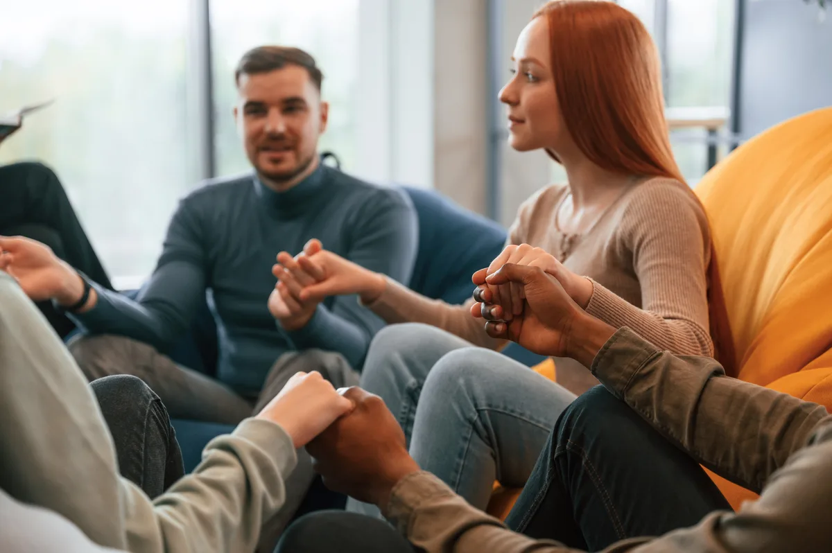 Marijuana Addiction: Friends holding hand and supporting one another
