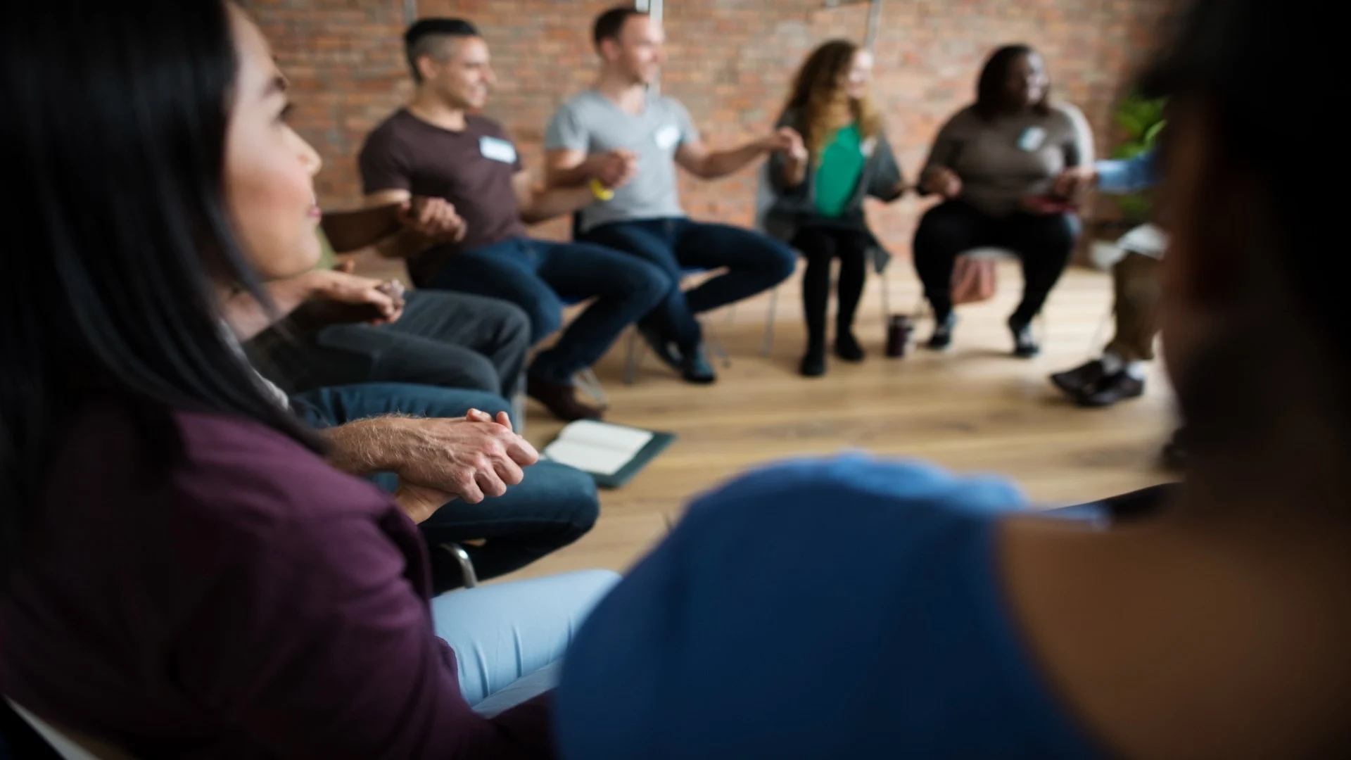Benzodiazepines list in the context of recovery support, showing a group therapy circle holding hands, emphasizing treatment and community for benzodiazepine addiction.