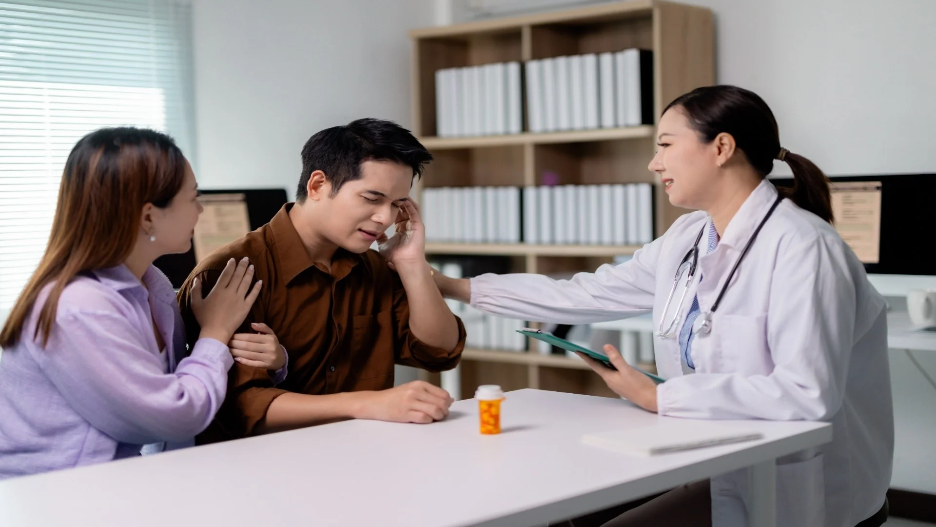 doctor-comforting-patient-suffering-from-headache-2025-04-06-08-25-42-utc