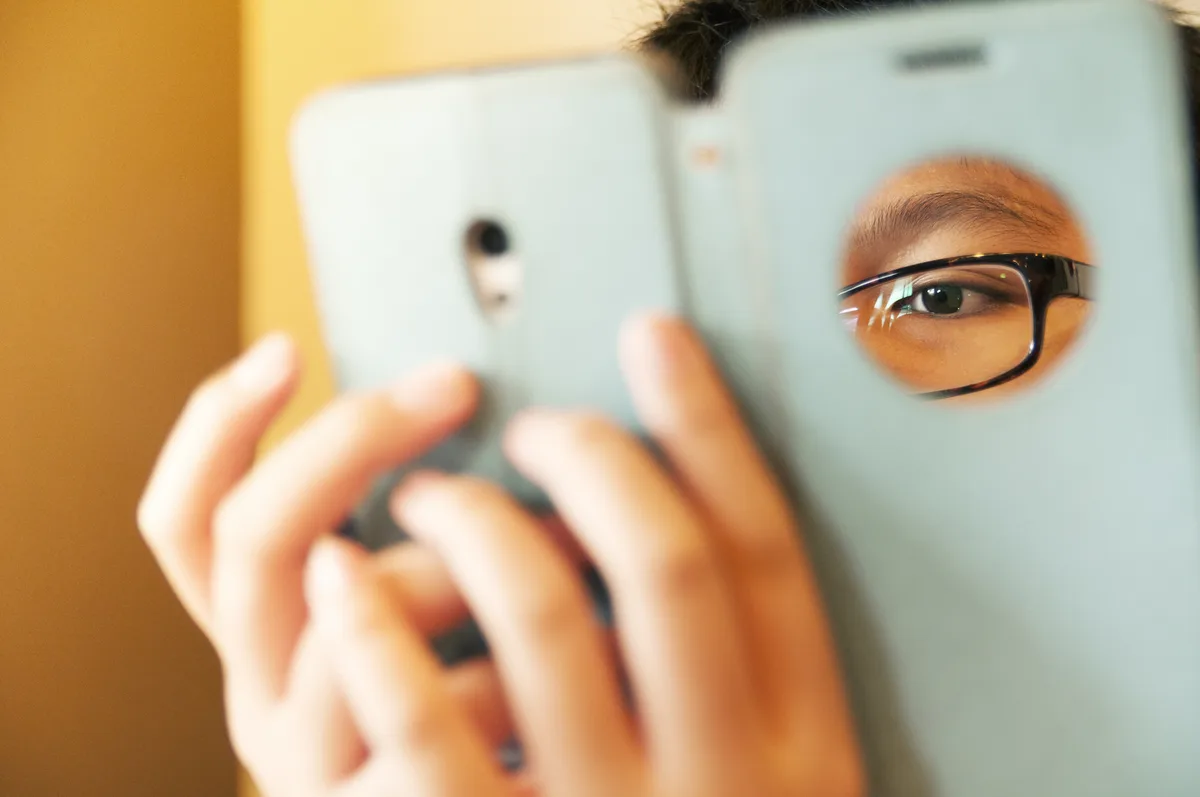 Phone Addiction: Man staring intensely at his phone