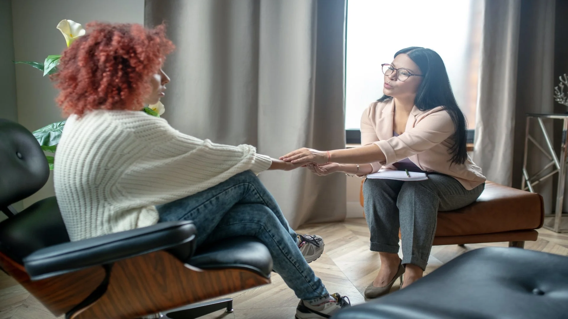 pleasant-psychologist-shaking-hand-of-her-stressed-2024-10-16-23-29-44-utc