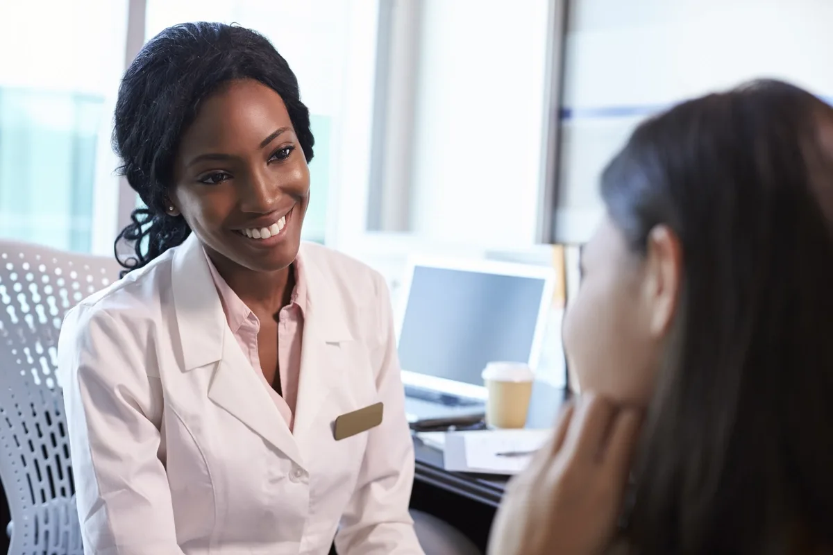 Case Management: Case manager talking to female patient