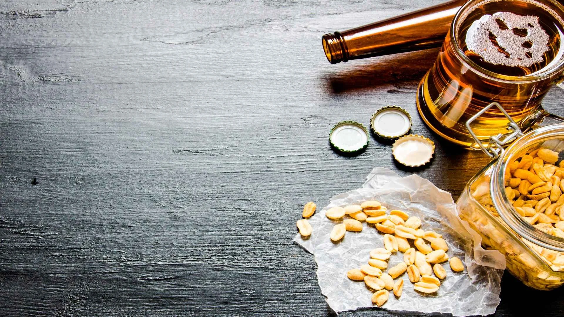 beer-with-peanuts-on-the-black-wooden-table-free-2024-11-01-04-44-40-utc