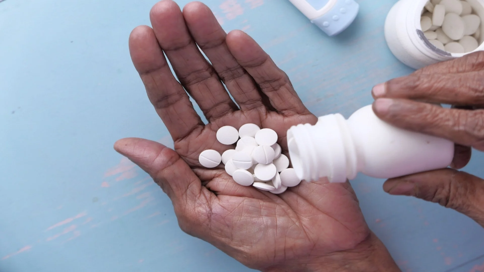 elderly-woman-pouring-pills-from-bottle-on-hand-wi-2024-12-10-04-23-15-utc