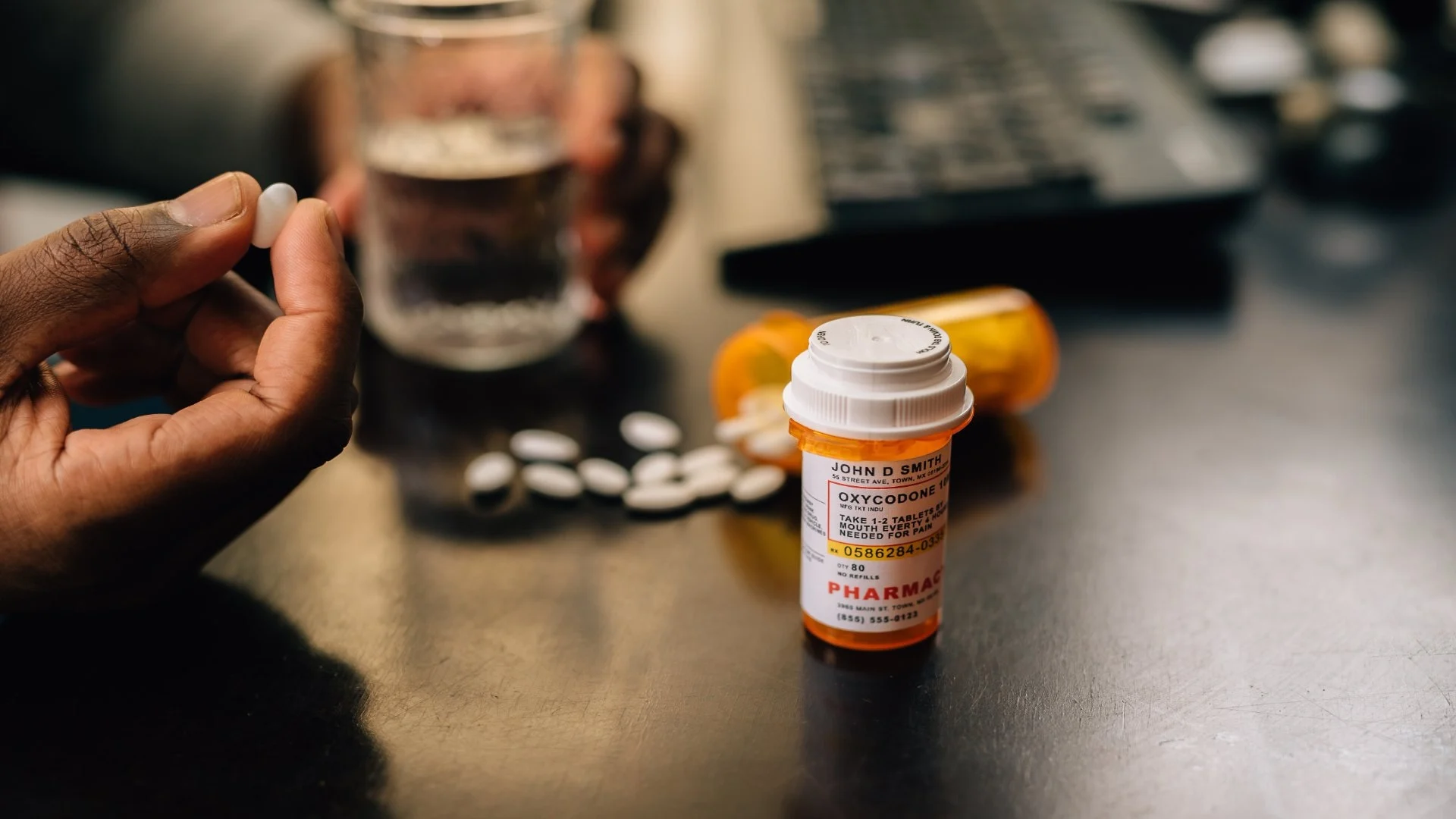 bottles-of-narcotic-pills-spilled-on-table-man-in-2024-09-22-19-15-14-utc