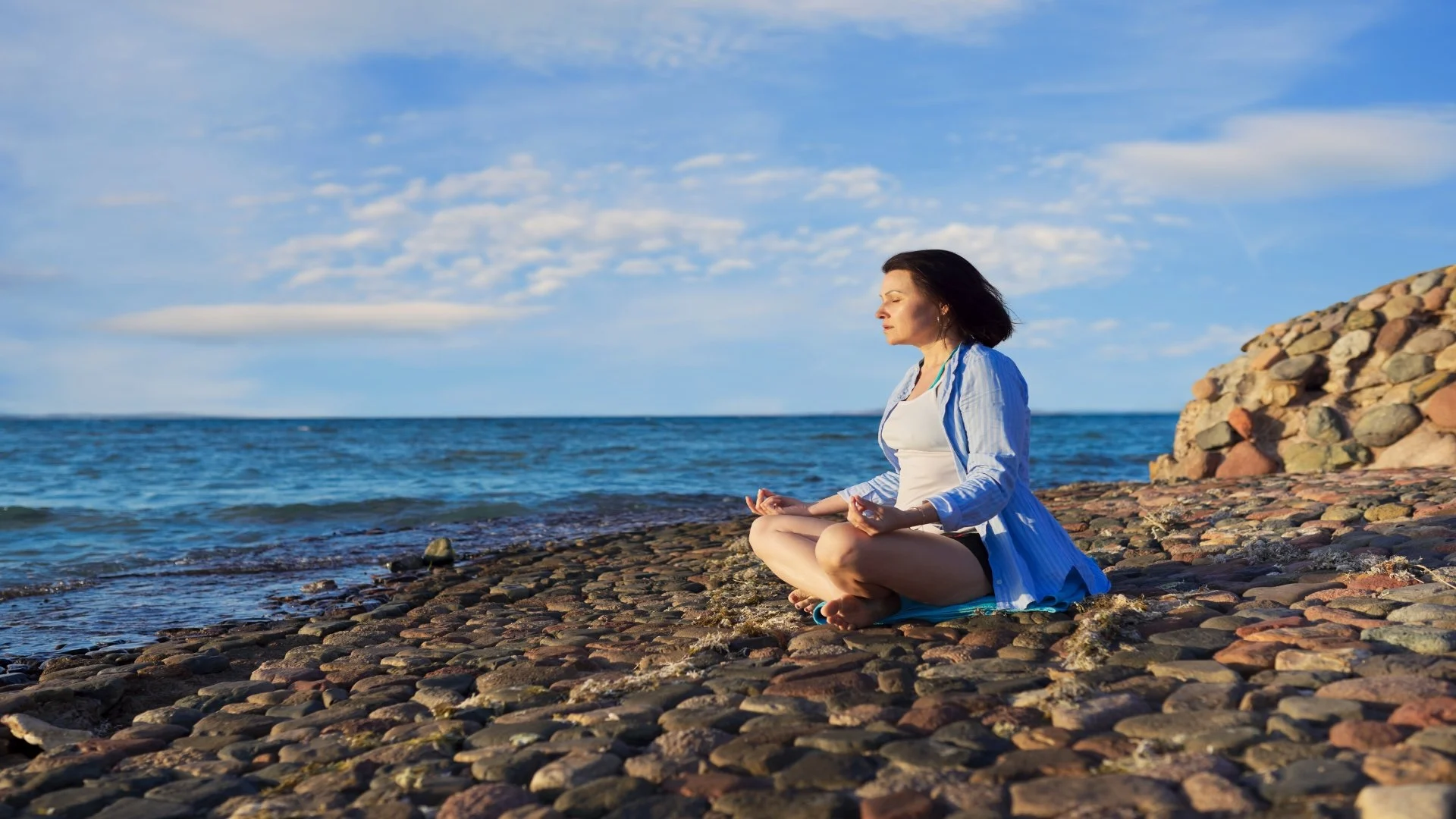 beautiful-middle-aged-woman-sitting-in-lotus-posit-2024-12-08-03-06-04-utc