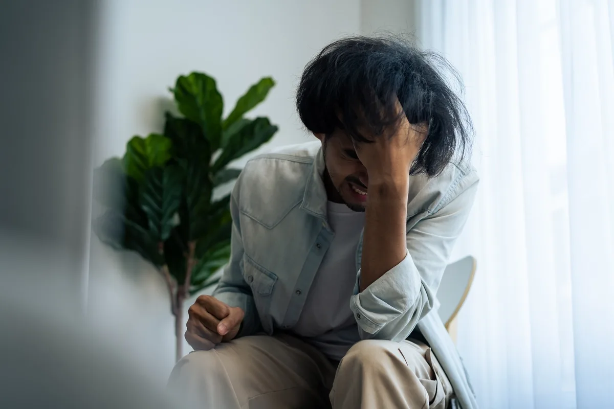 Fentanyl Addiction: Man with face in palm