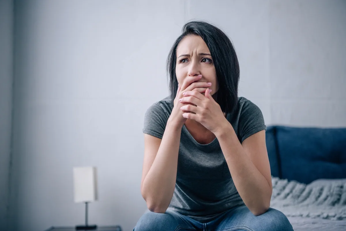 Xanax Addiction: Distraught woman with her hands over her mouth