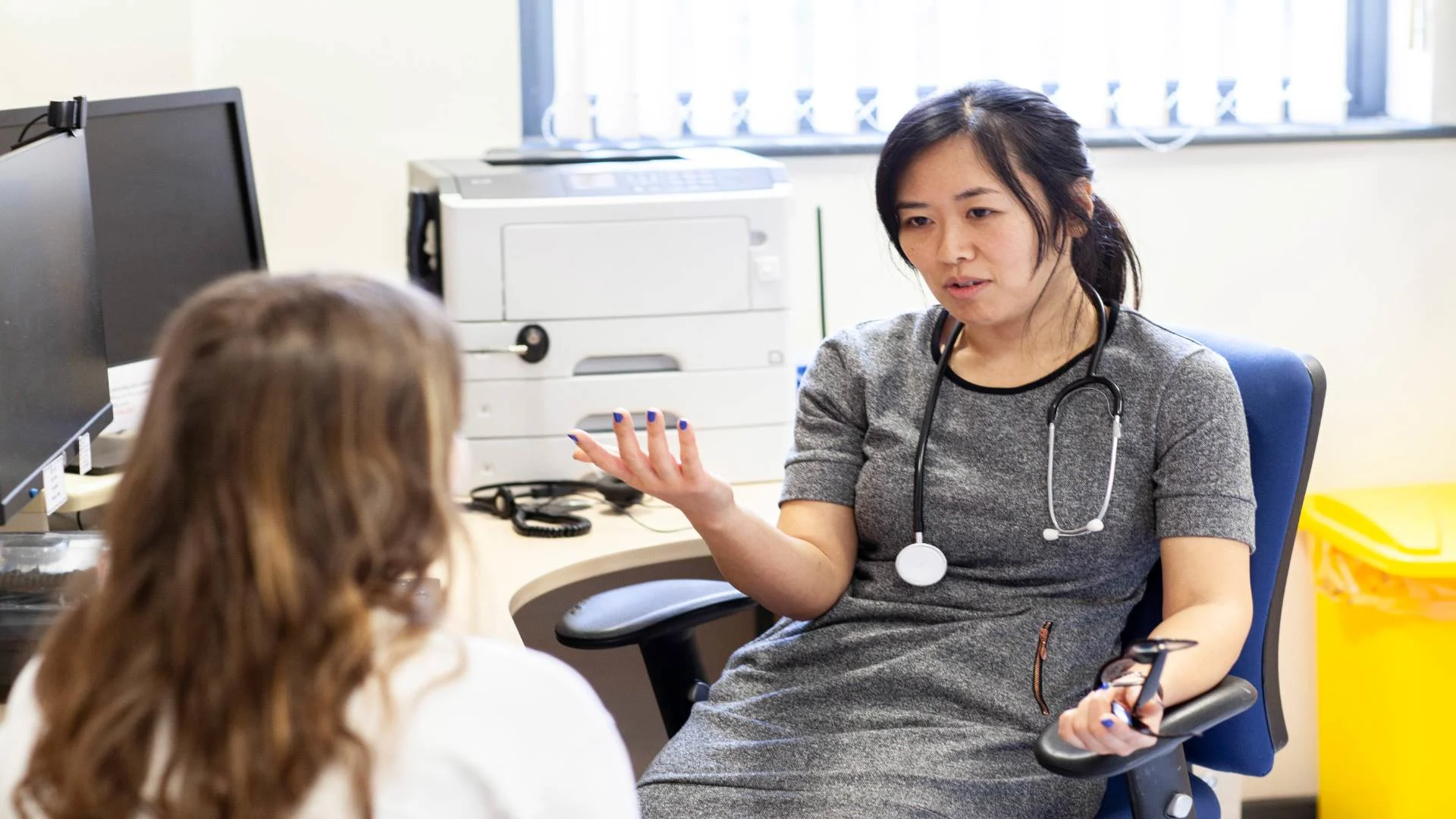 doctor discussing microdosing shrooms implications with patient in office.