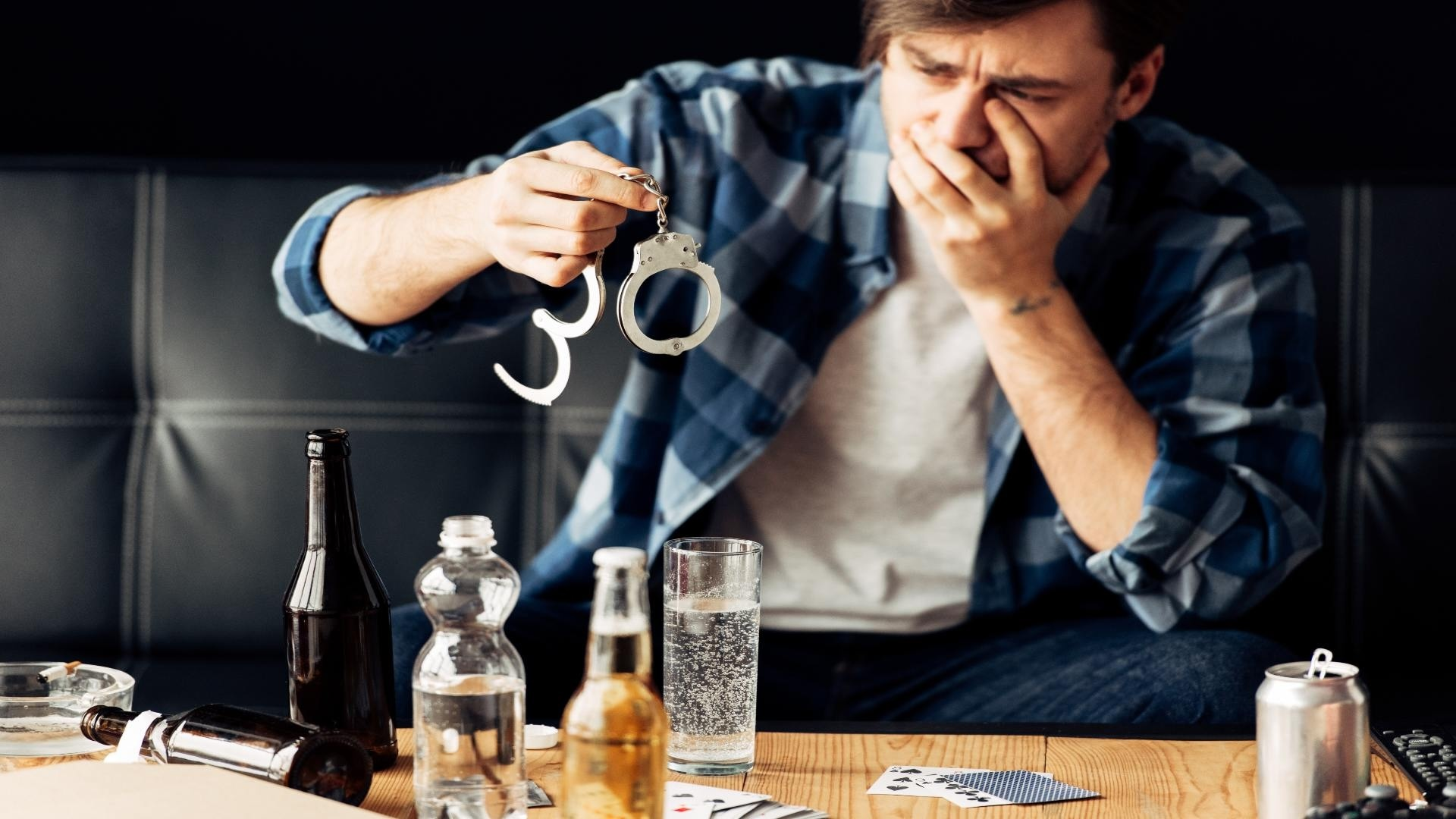 man-covering-face-while-looking-at-handcuffs-after-2024-11-14-06-35-16-utc