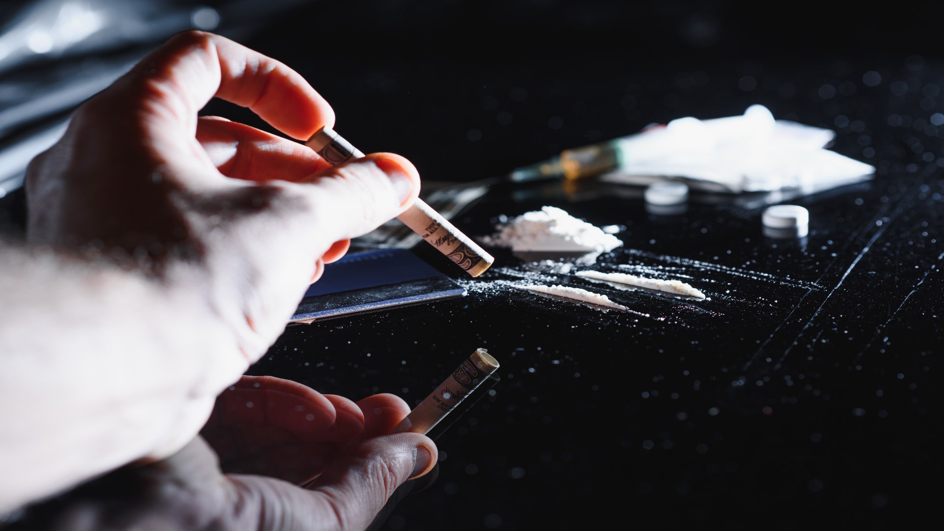 A person prepares to use a rolled dollar bill to inhale white powder, a disturbing yet common behavior tied to signs of meth use. A person prepares to use a rolled dollar bill to inhale white powder, a disturbing yet common behavior tied to signs of meth use.