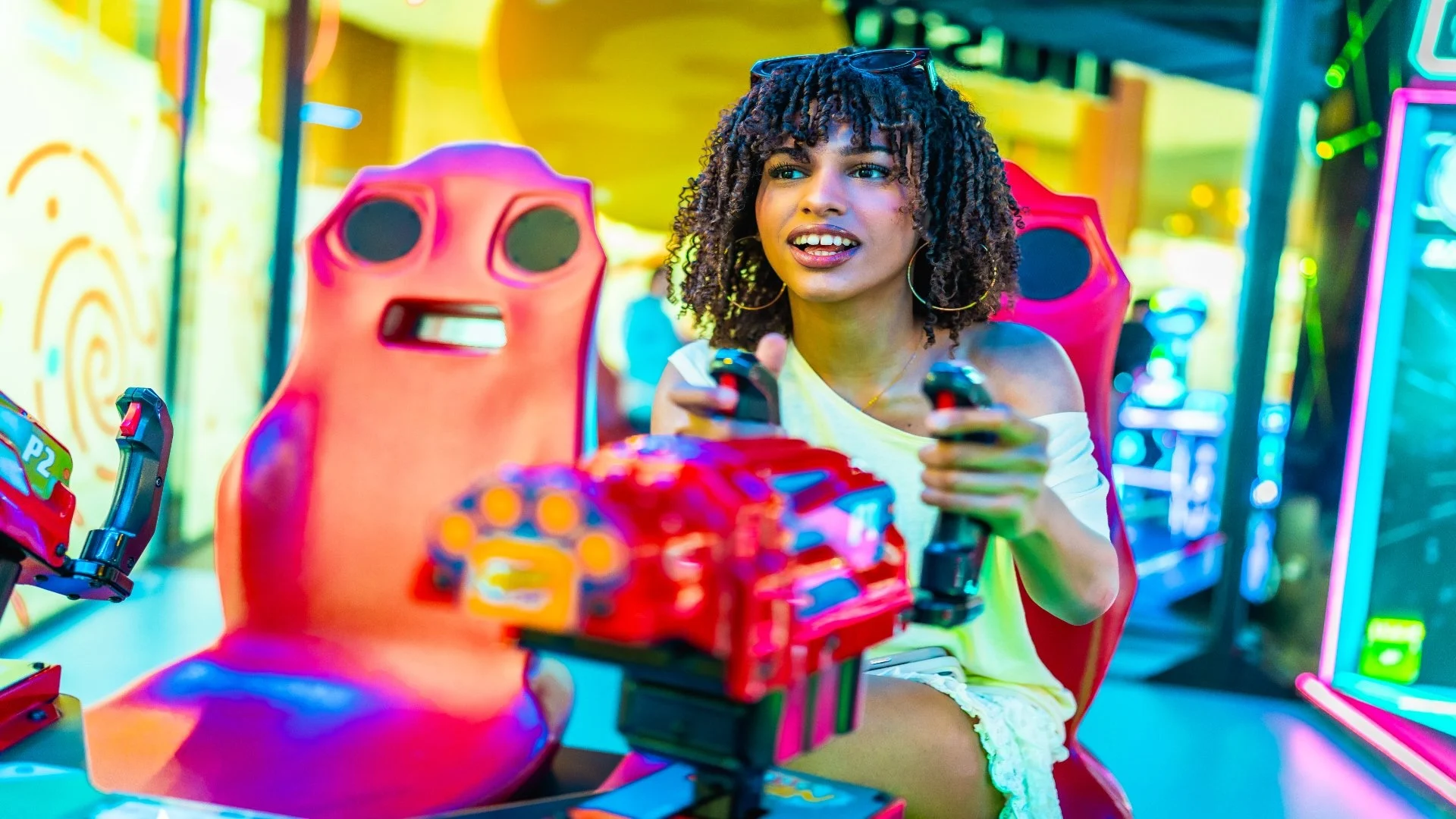 young-woman-playing-arcade-racing-game-in-a-shoppi-2025-08-18-00-24-40-utc