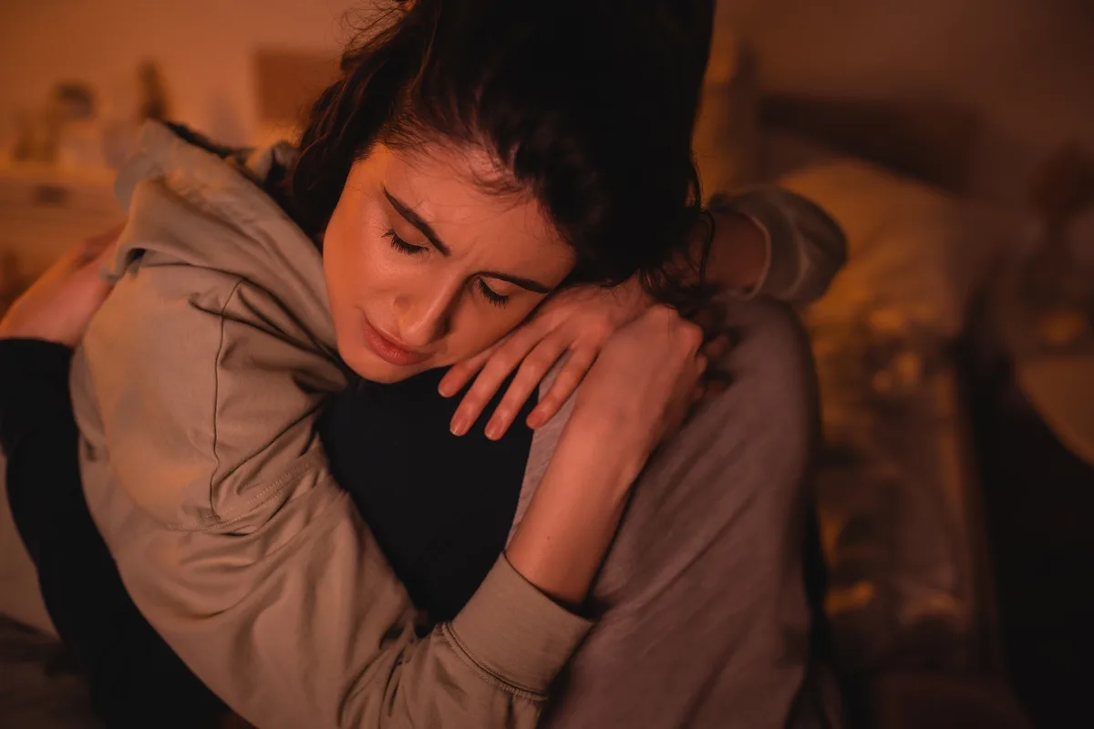 Sad Woman with Generalized Anxiety Disorder Curled Up