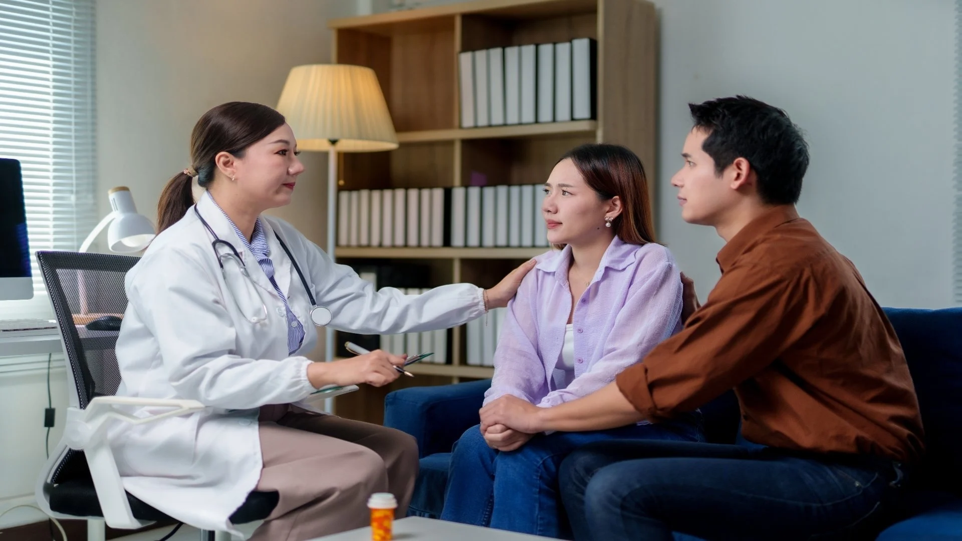 doctor-comforting-sad-couple-during-consultation-i-2025-07-22-19-20-19-utc
