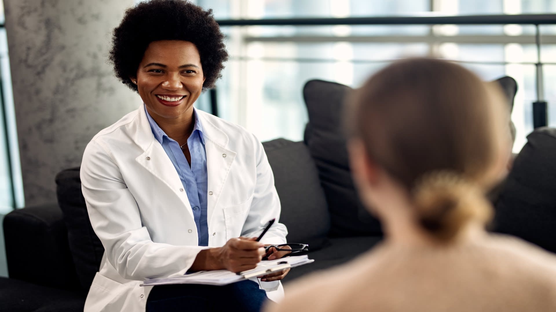 happy-african-american-doctor-talking-with-female-2024-12-13-17-10-19-utc (1)